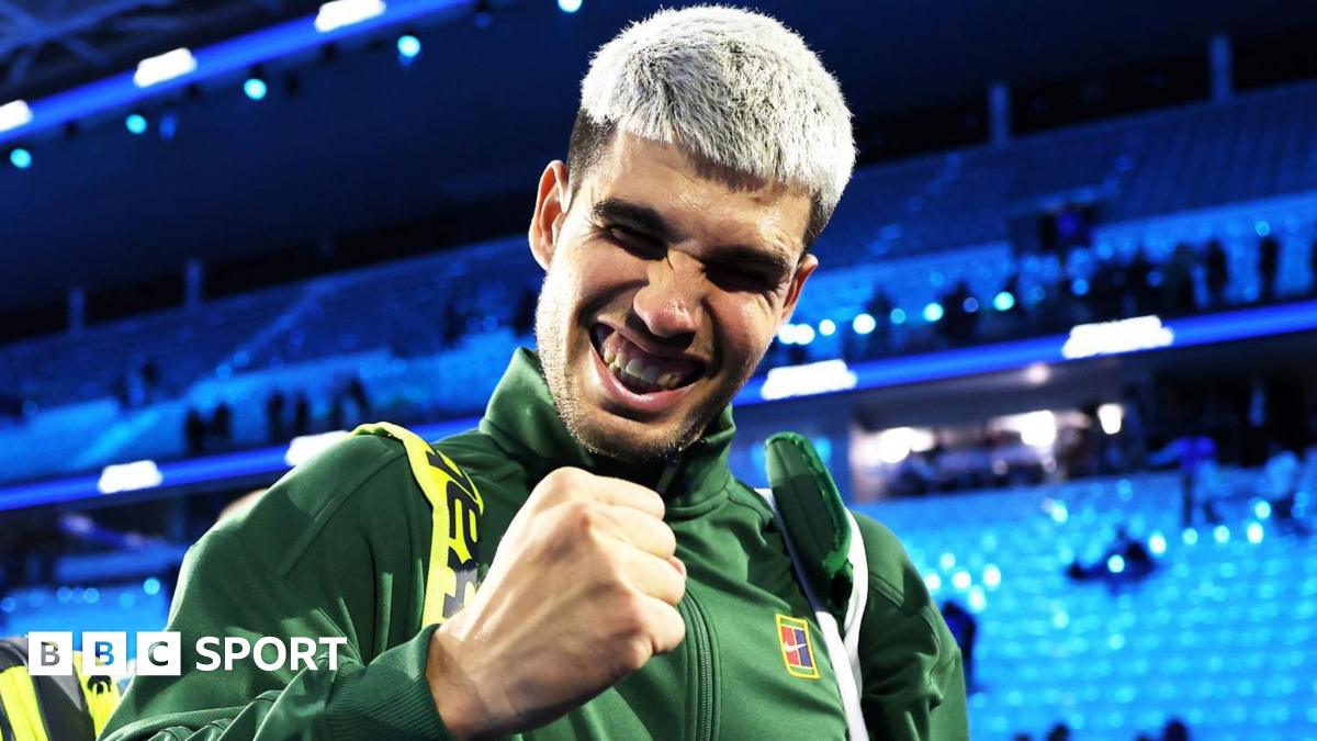 Carlos Alcaraz clenches his fist in celebration as he walks off the court following his win over Taylor Fritz